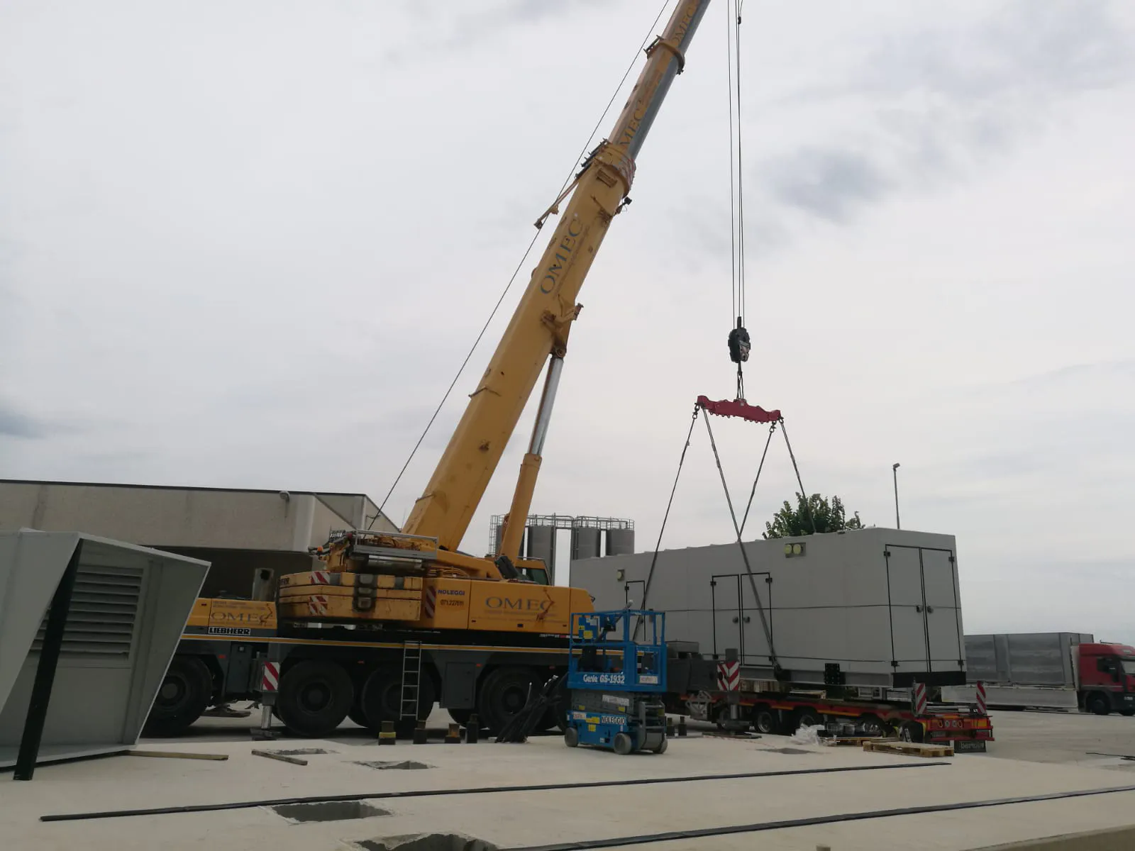 FlexEgen gas CHP module craned into position — single-lift install of a pre-assembled gas engine CHP package.